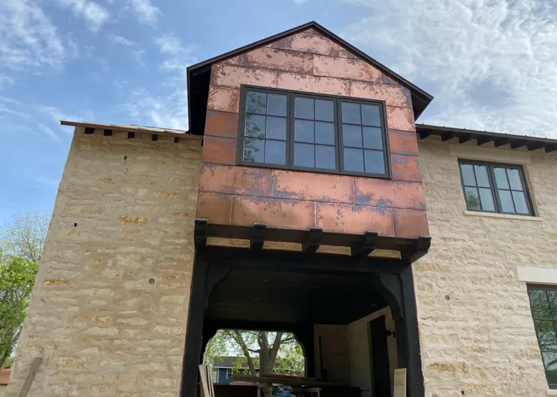 Copper metal panel facade on a stone building for Skylight Installation in Camillus